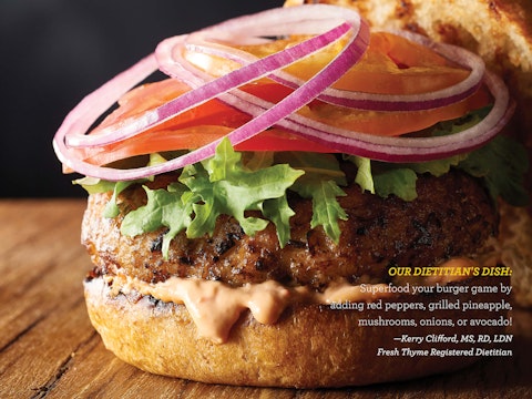 A juicy hamburger close up for Fresh Thyme Market's Crave magazine.