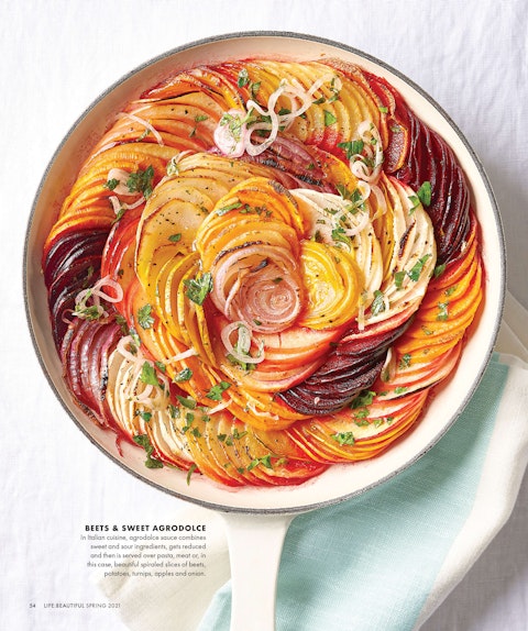 A spread of a potato recipe from Life:Beautiful magazine, featuring a baking dish full of sliced potatoes.