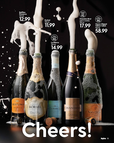 A spread of a New Year's Eve drinks story from Hy-Vee Mega Ad magazine, featuring bottles of champagne popping their corks.